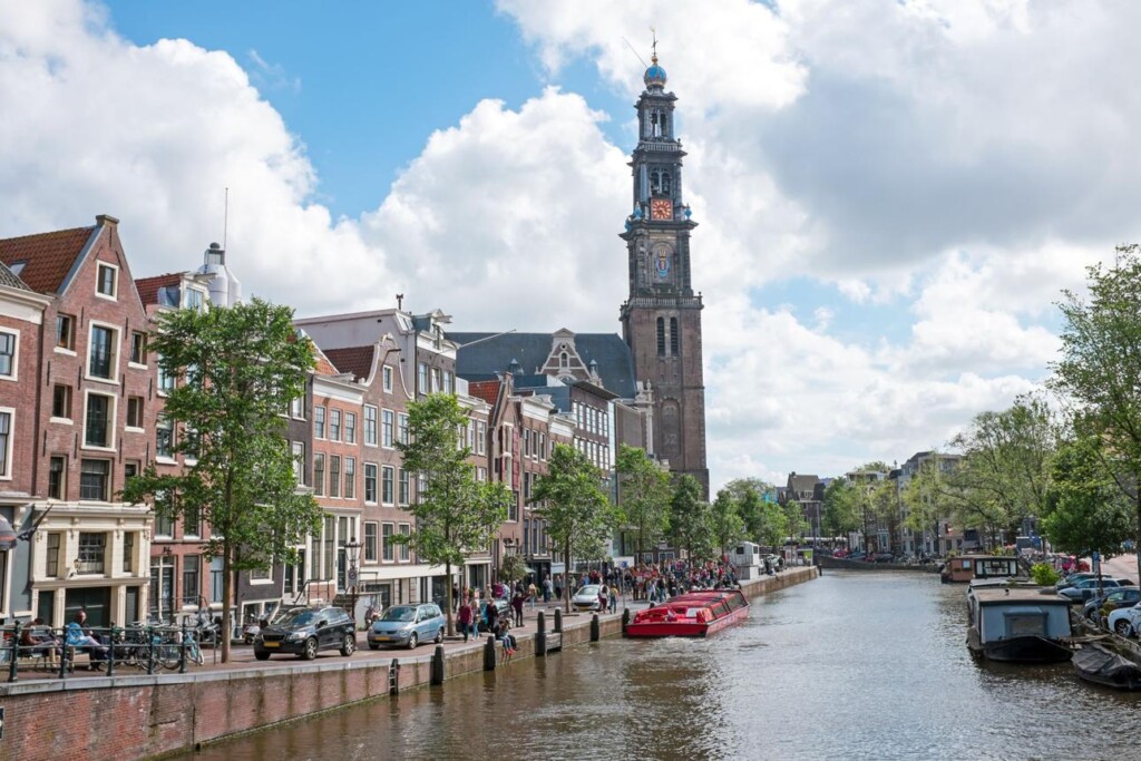 Historic Amsterdam canal houses and bridges during a scenic walking route