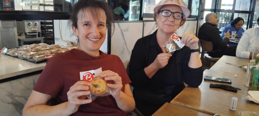 Brunch at Bem Bom Cafe during Walking Group social. A free 'pastel de nata' was presented to each of the ladies. L to R: Lauren and Candice displaying their 'pasteis de natas'