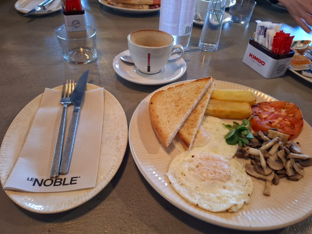 Breakfast consisting of fried eggs, mushrooms, farm potatoes, tomato and toast served at Le Noble Restaurant in Bedfordview.