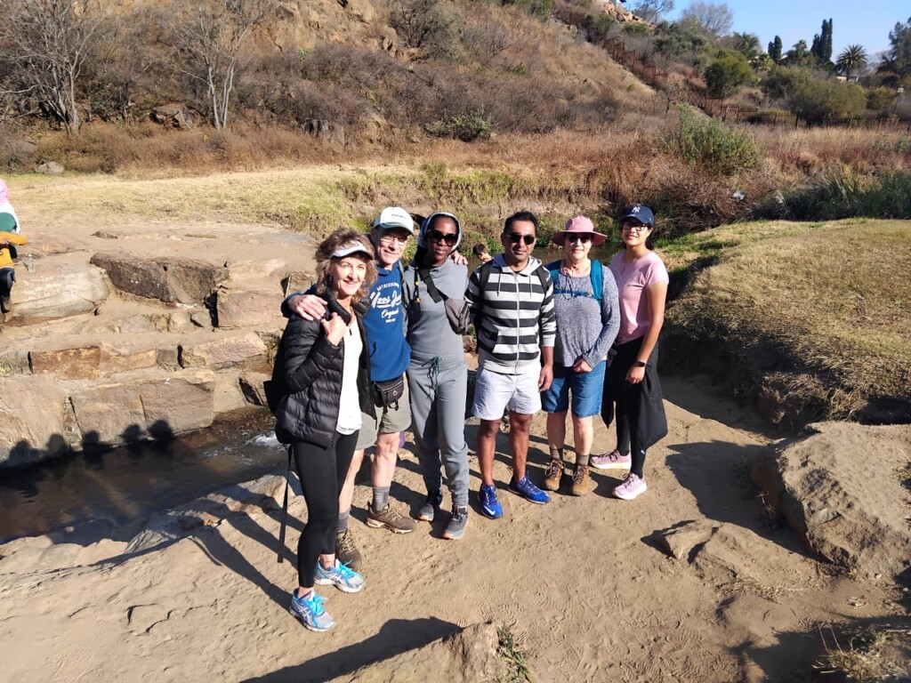 Hikers posing beside the Silent Pool area at Klipriviersberg Nature Reserve during a social group hike.