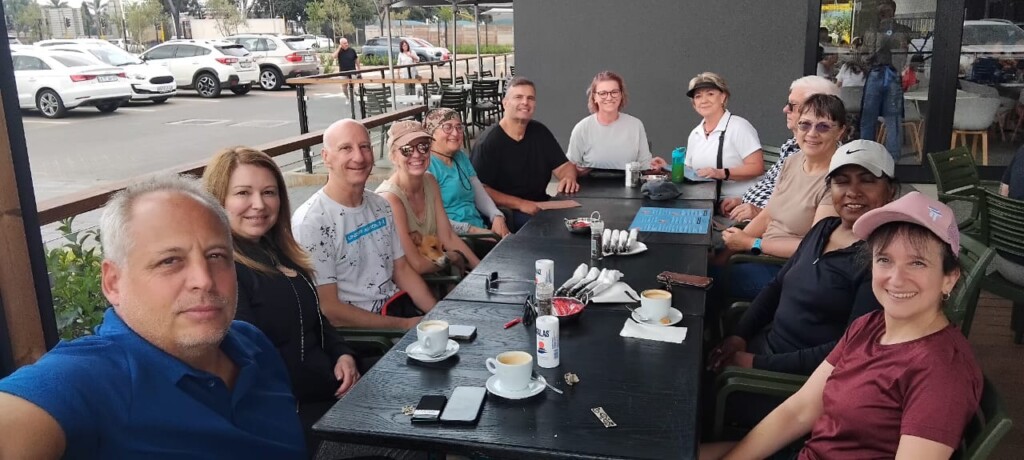 Walking group enjoying breakfast and coffee on the outdoor patio at Café BilliBi, Bedford Crossing, Bedfordview.