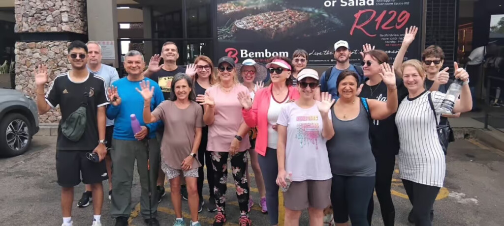 Walking group gathering outside Bembom Bedfordview before setting off on a group walk.