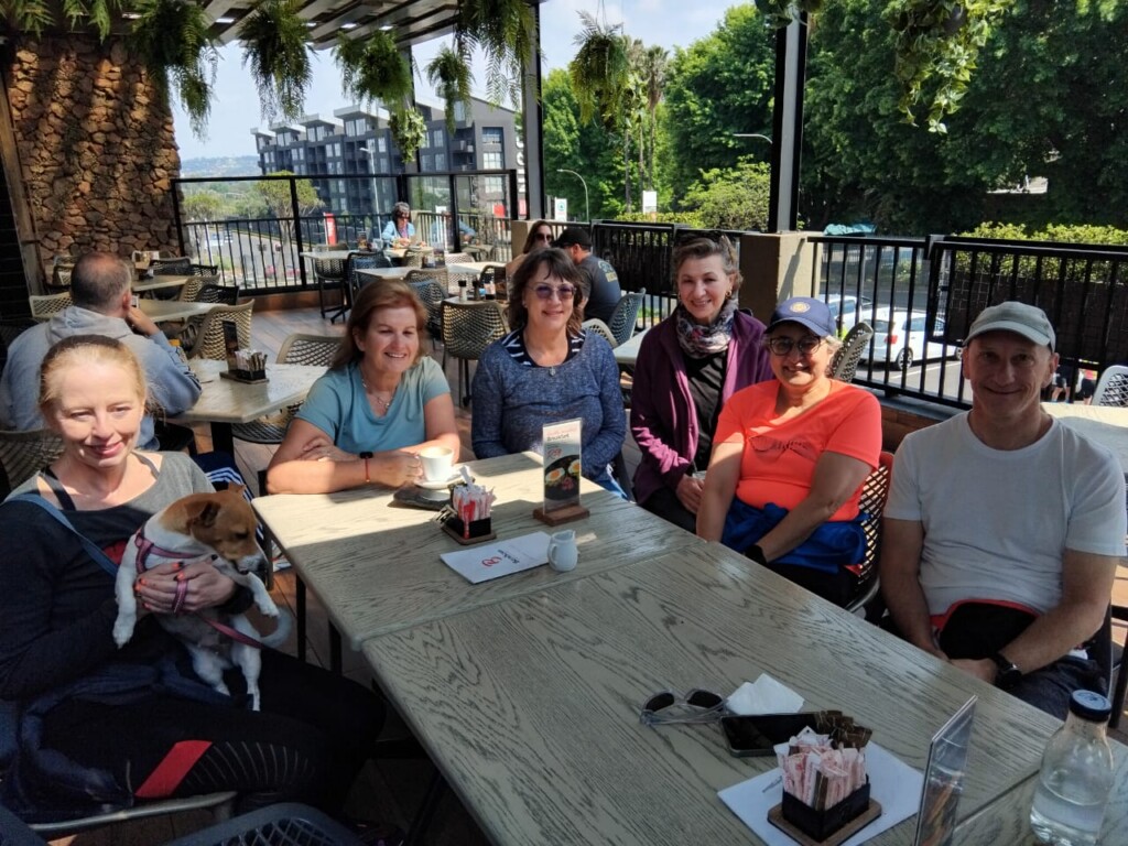 Members of the Bedfordview walking group enjoying coffee and brunch on Bem Bom Café's outdoor terrace.
