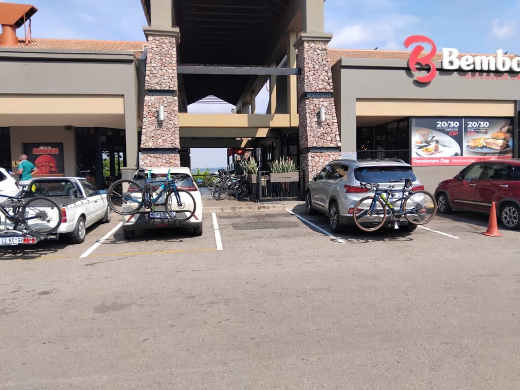 Road bicycles parked outside Bem Bom Portuguese Café during a cycling stop in Bedfordview.