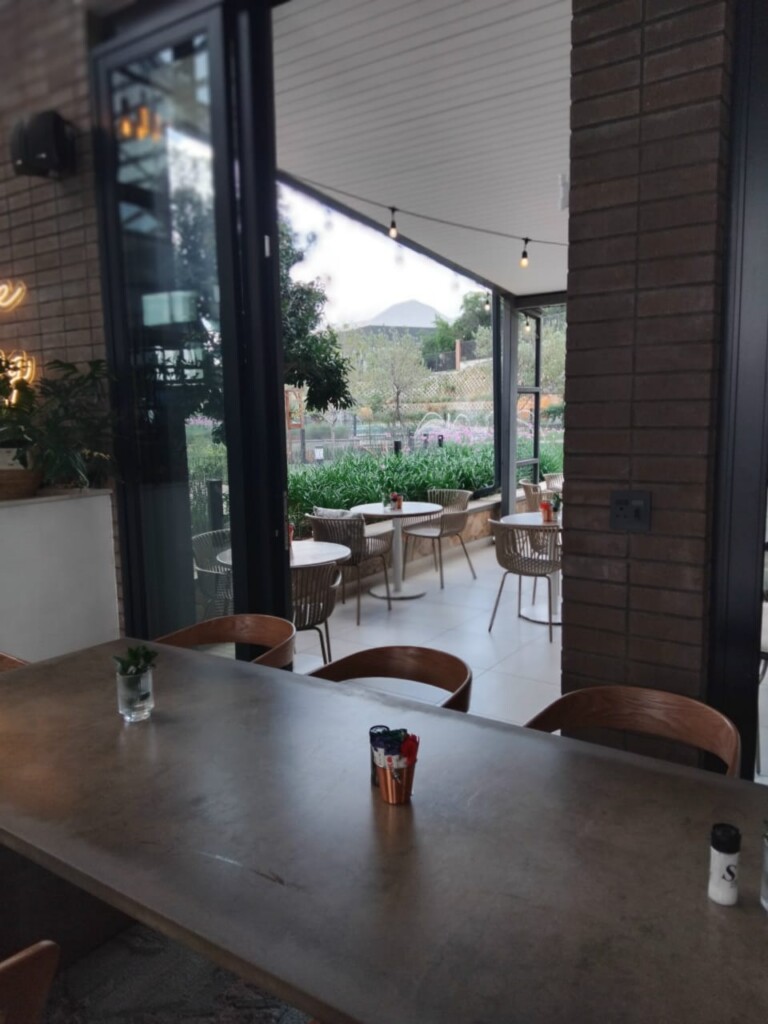 Outdoor seating area and garden view at Just Darling Thaba Eco Village