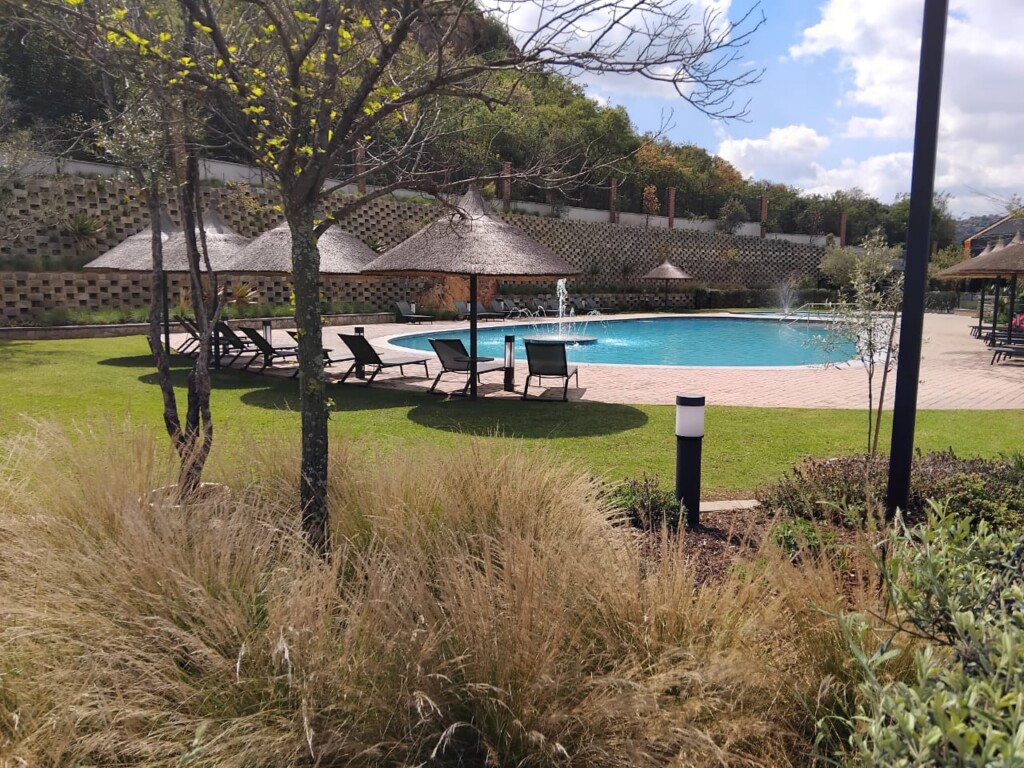 Swimming pool and landscaped gardens at Thaba Eco Village in Johannesburg